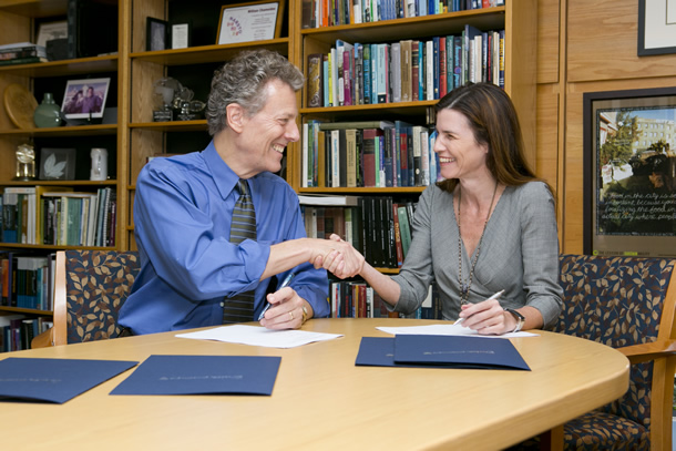 Photo of William L. Chameides and Paula Ehrlich shaking hands.