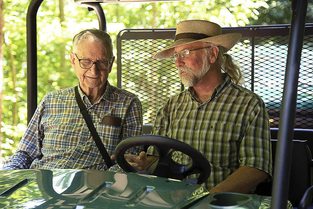 Image of E.O. Wilson with another man on a golf cart.