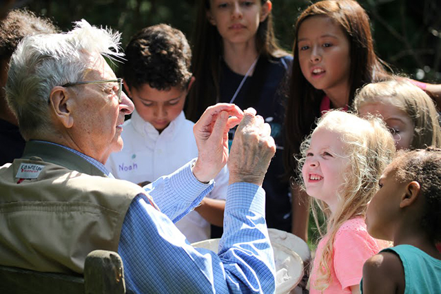 Image of E.O. Wilson speaking to children.