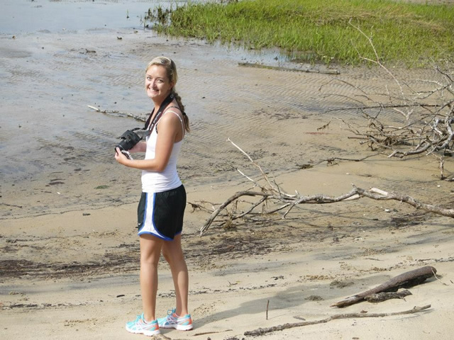 Image of Casey Johnson standing in sand near water.