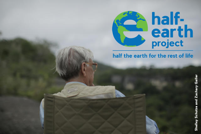Image of E.O. Wilson sitting in a chair with the Half-Earth logo in the top right corner.