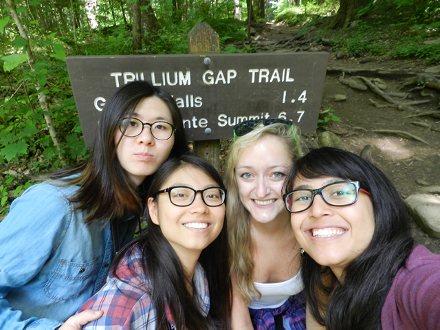 Selfie of 4 girls in front of the Trillium Gap Trail. 