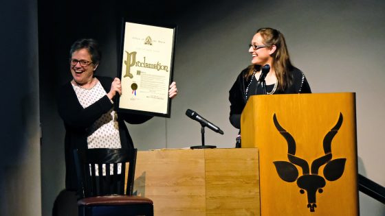 Image of Catherine Werner (at right), the sustainability director for the City of St. Louis, reads a proclamation held by Whitney R. Harris World Ecology Center interim Director Patricia Parker.