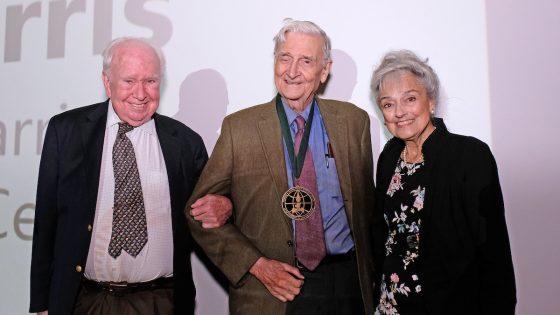 Image of Peter Raven (left) and Anna Harris (right) stand with Edward O. Wilson after presenting him with the World Ecology Award.