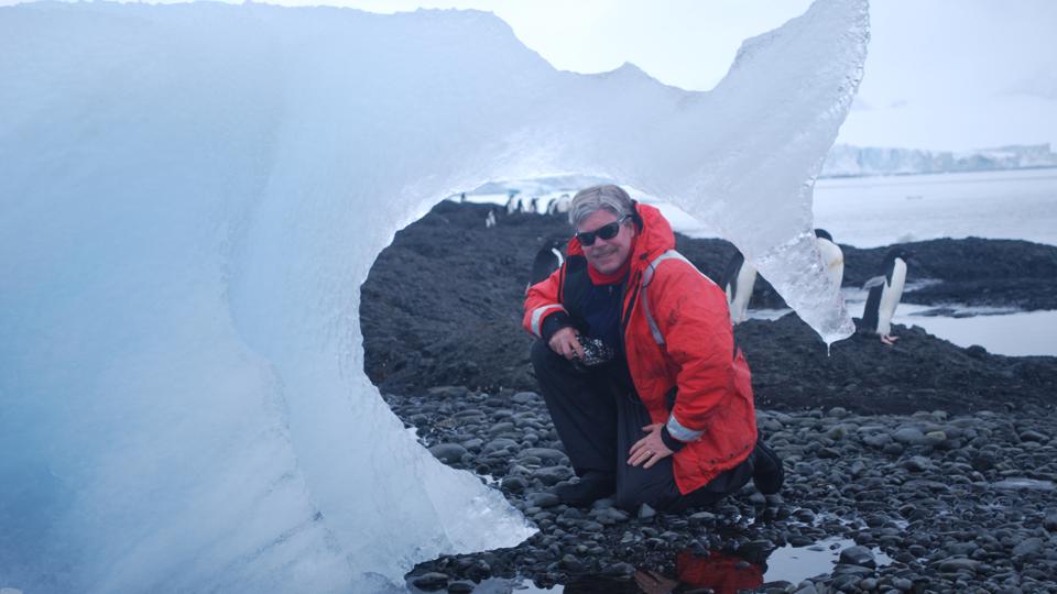 Man standing in front of ice. 