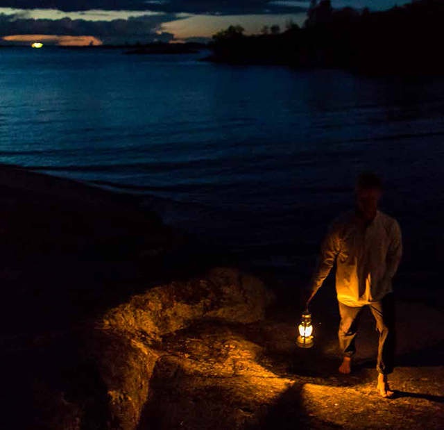 Man walking in the dark with a lantern. 