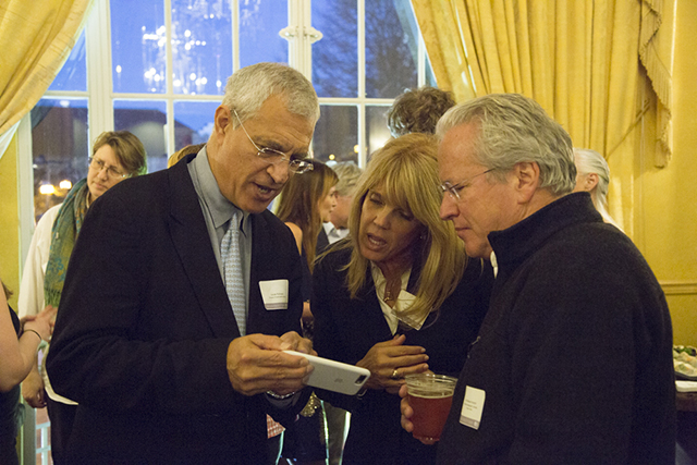 Image of Louie Psihoyos, Laura Turner Seydel and Jon Bowermaster looking at an iPhone.