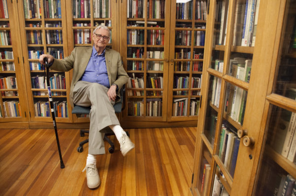 E.O. Wilson sitting in front of his home library.