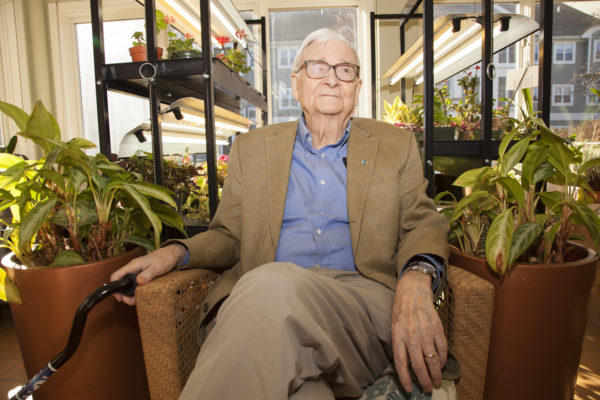 E.O. Wilson siting in a sunroom.