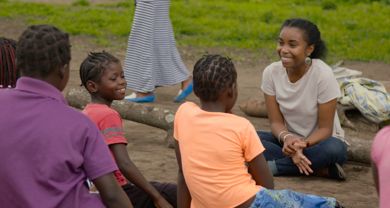 Image of Dominique Gonçalves laughing with a Girls Club group in Gorongosa.