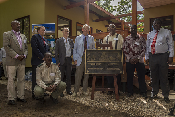 Image of a group of people standing at a plaque.