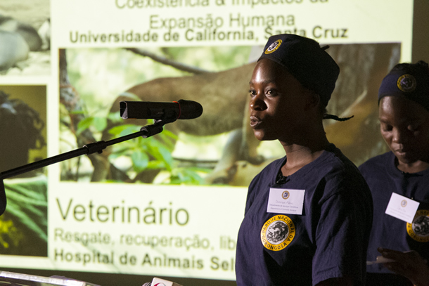 Image of a woman speaking into a microphone.