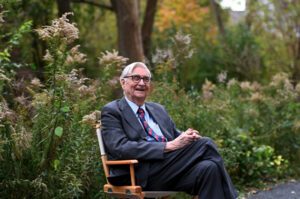 Image of E.O. Wilson sitting in a chair outside.