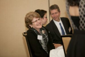 Image of a woman smiling in her seat.