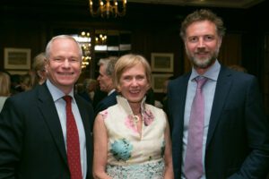 Image of three people smiling at the camera.