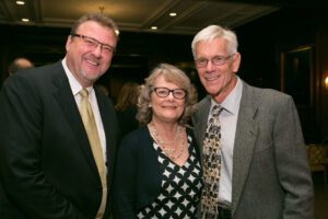 Image of three people smiling at the camera.