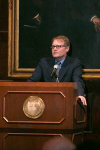 Image of Greg Carr giving a speech. 