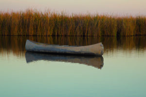 Image of a canoe on the still water.