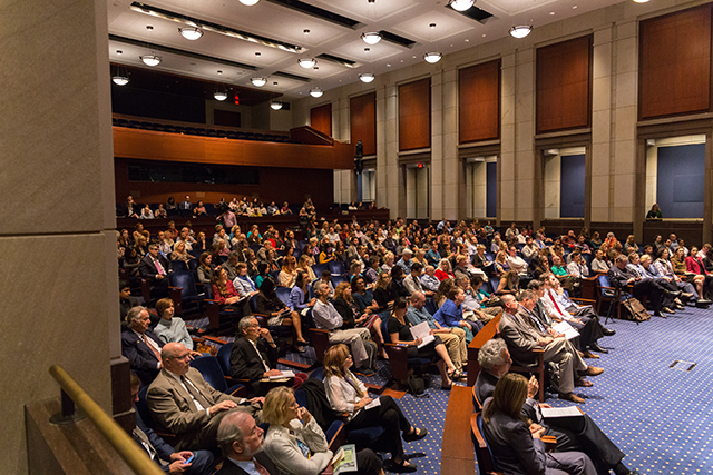 Image of a full crowd in an auditorium.