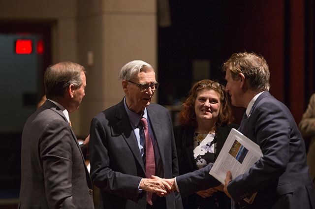 Image of E.O. Wilson shaking hands with another man.