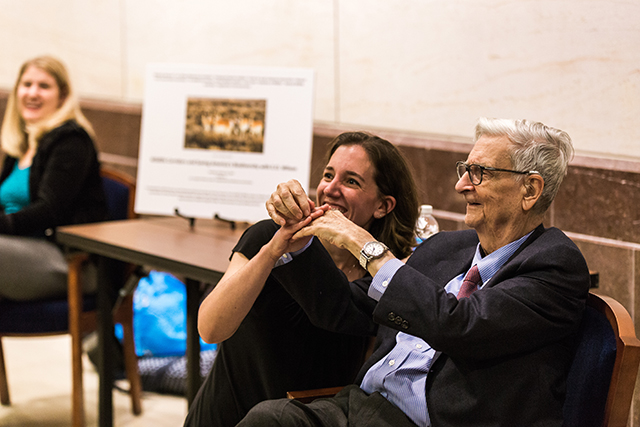 Image of E.O. Wilson holding hands with a fan.