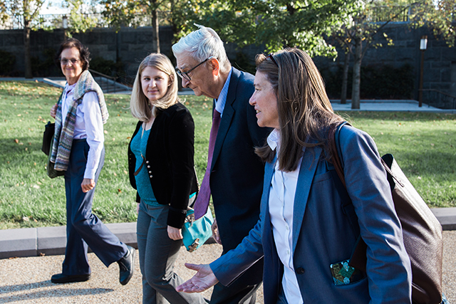 Image of E.O. Wilson walking with some people.