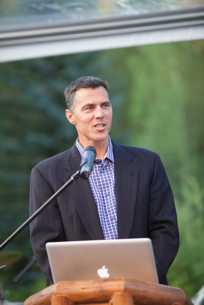 Image of a man on stage speaking.