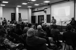 Image of a young man speaking to a crowd.