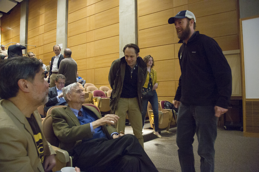 Image of several men speaking to E.O. Wilson.