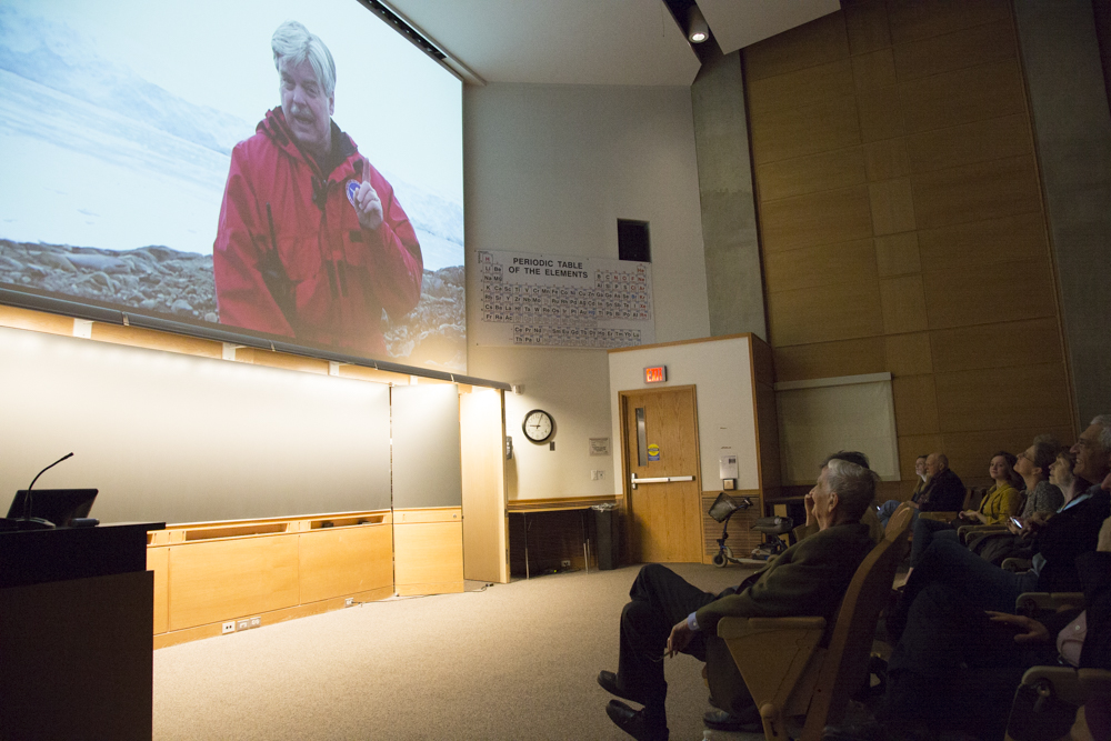 Image of a crowd of people watching Jim McClintock on the screen. 