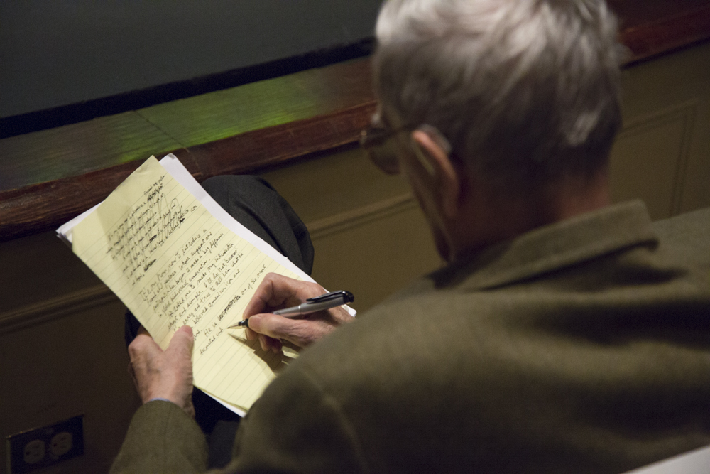 Image of E.O. Wilson writing on a piece of paper.