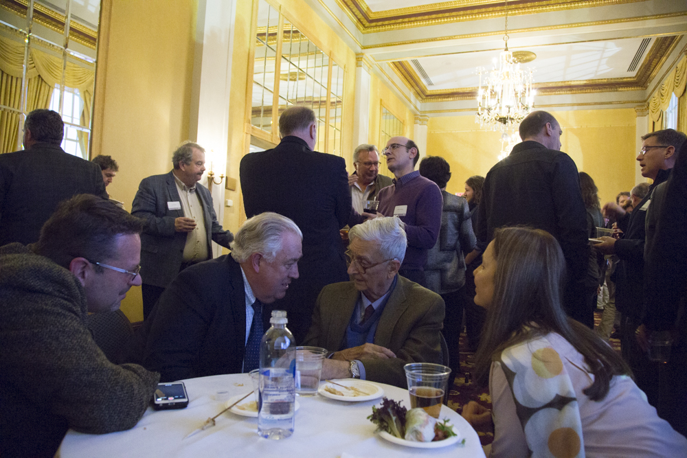 Image of E.O. Wilson surrounded by people at a table.