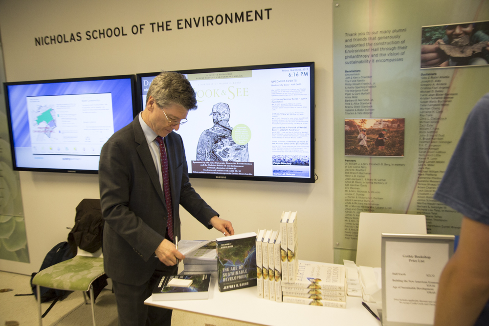 Image of Jeff Sachs standing next to books.