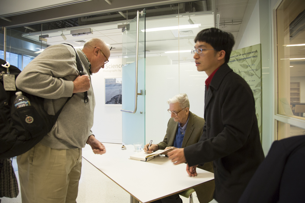 Image of E.O. Wilson signing books.