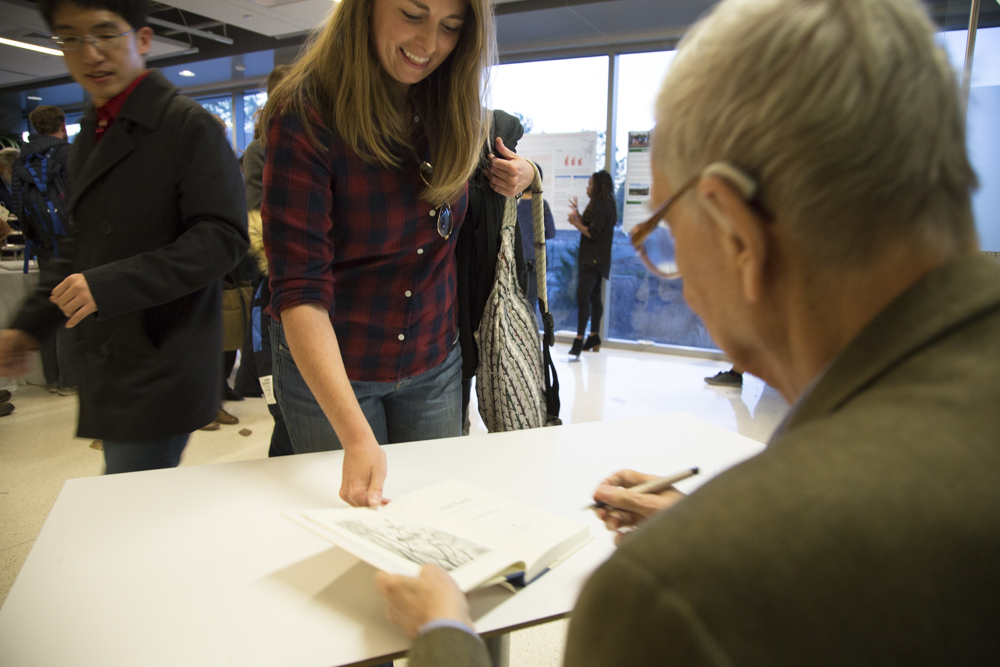 Image of E.O. Wilson signing books.