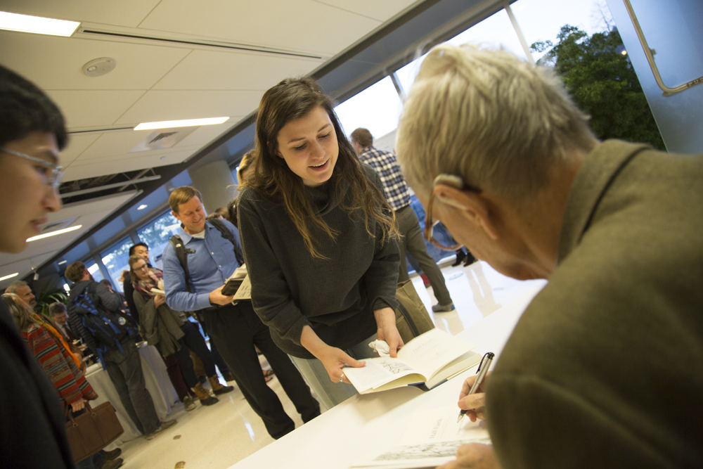 Image of E.O. Wilson signing books.